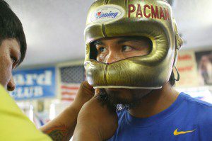 June 4, 2012, Hollywood, Ca. ---"FOCUSED AND READY TO ROLL" Superstar Manny Pacquiao(R) gets his headgear adjusted by assistant trainer Buboy Fernandez(L) during his final day of training camp at the Wildcard Boxing Club in Hollywood,Ca. on Monday. Pacquiao and his team will head to Las Vegas Monday night in preparation for his upcoming World Welterweight title mega-fight against undefeated Jr. Welterweight champion Timothy "The Desert Storm" Bradley Jr.. Promoted by Top Rank, in association with MP Promotions, Tecate, AT&T and MGM Grand, Pacquiao vs Bradley will take place, Saturday, June 9 at the MGM Grand in Las Vegas, live on HBO Pay Per View. --- Photo Credit : Chris Farina - Top Rank (no other credit allowed) copyright 2012